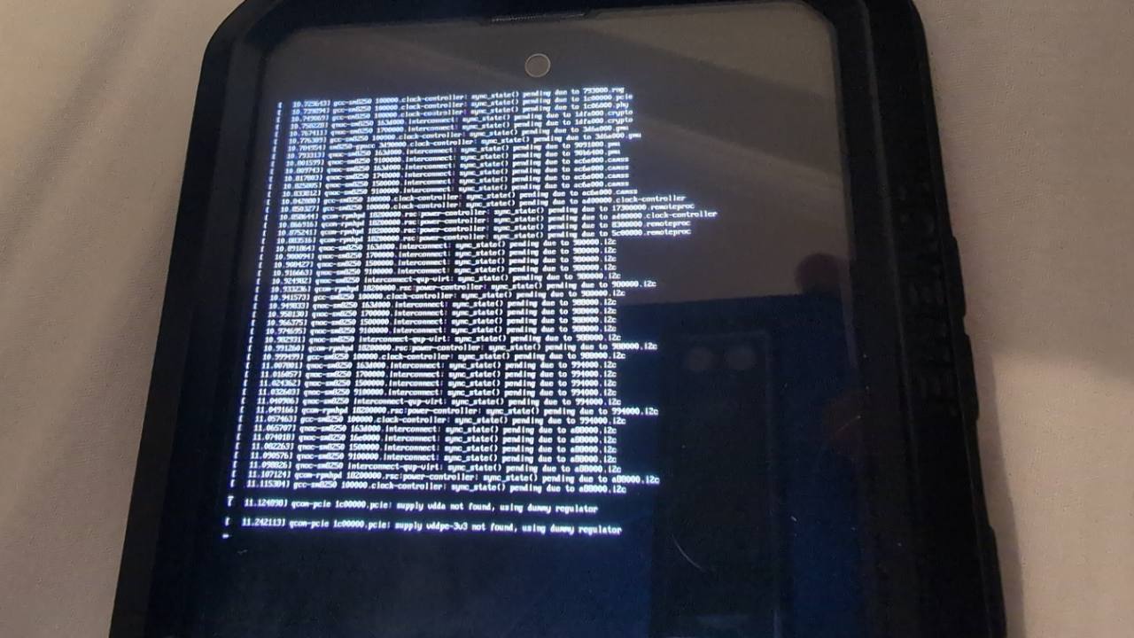 The Samsung phone displaying Linux kernel messages during an early boot