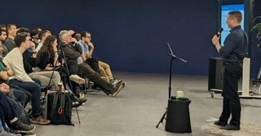 The author, standing on stage with a microphone